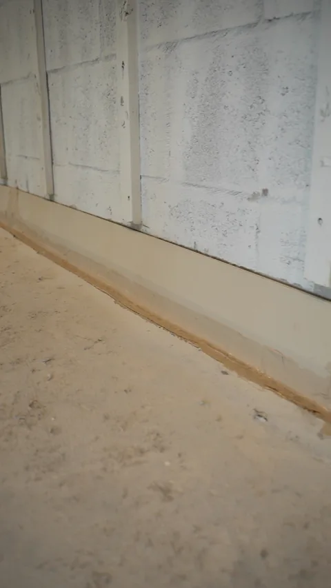 Strip along the base of an unfinished interior masonry wall